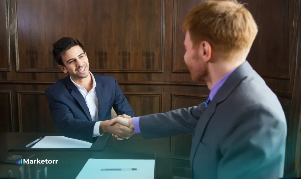 2 man is handshaking wearing suite